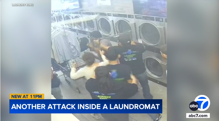 attacker being sprayed with pepper spray by a laundry employee as other employees look on